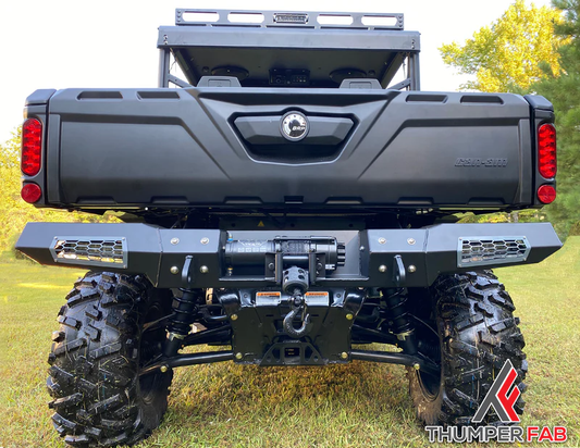 Back view of Can-Am Defender on grassy terrain